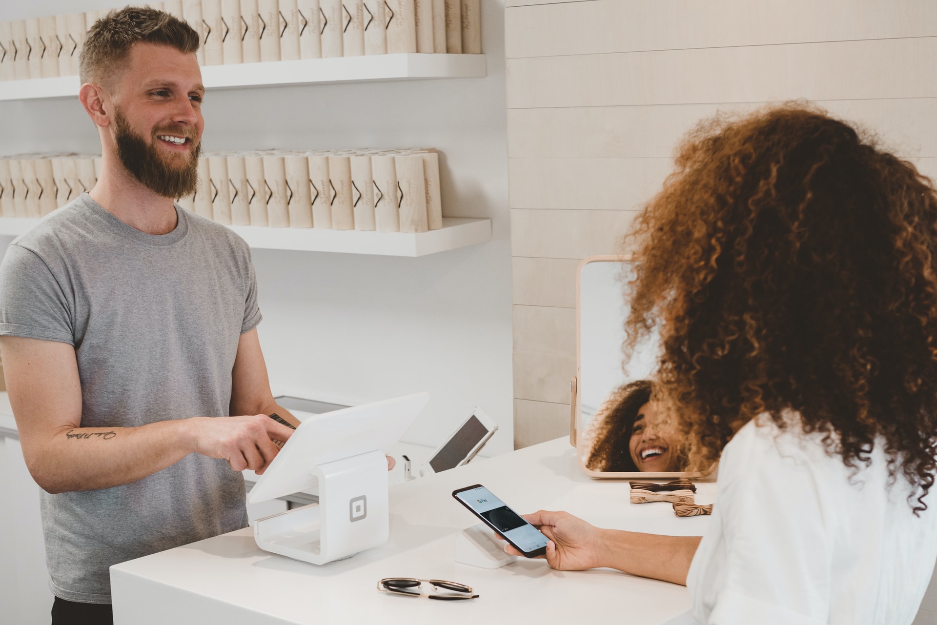 a small business owner transacting with a customer