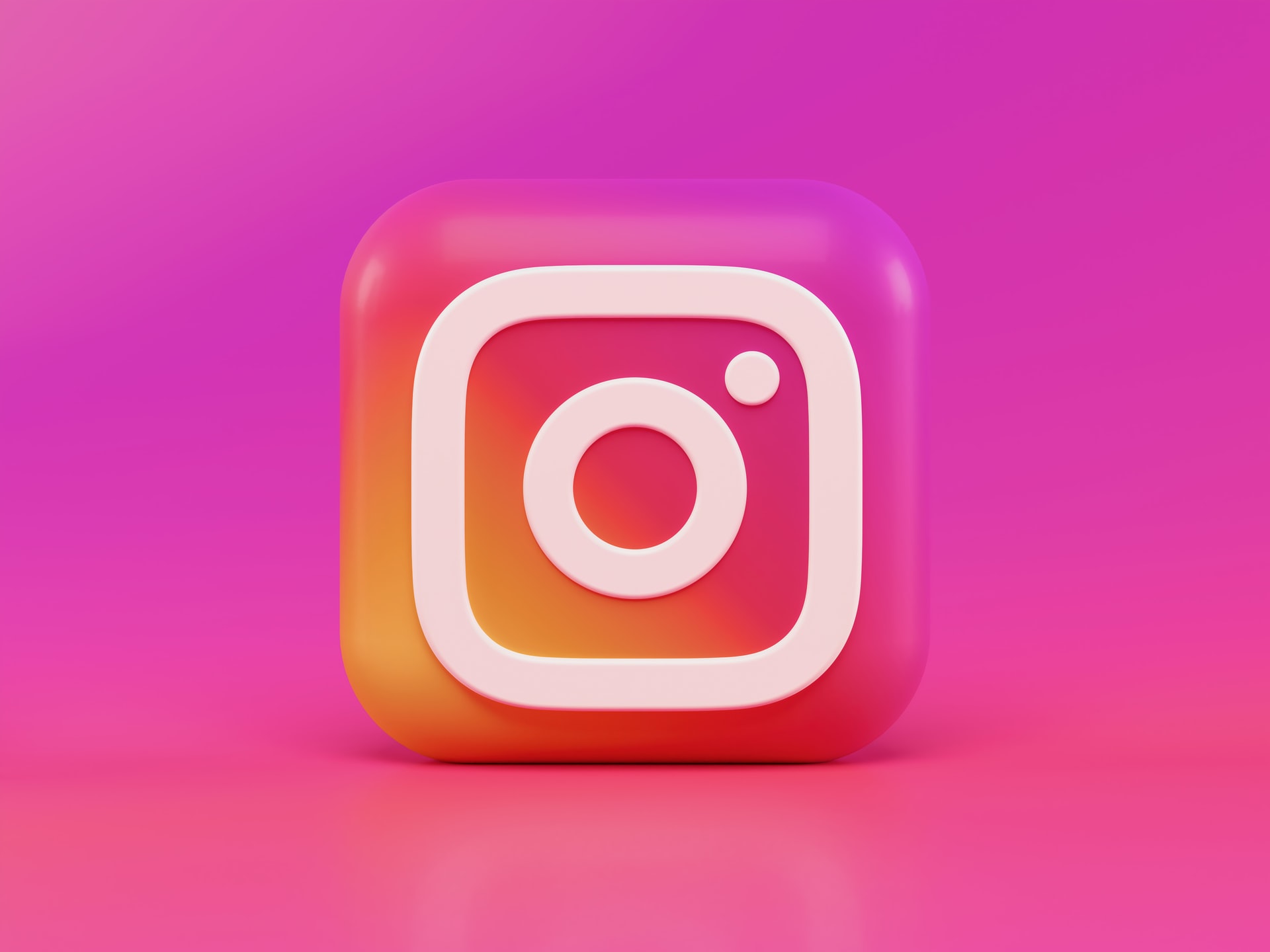instagram logo in 3D form against a pink background