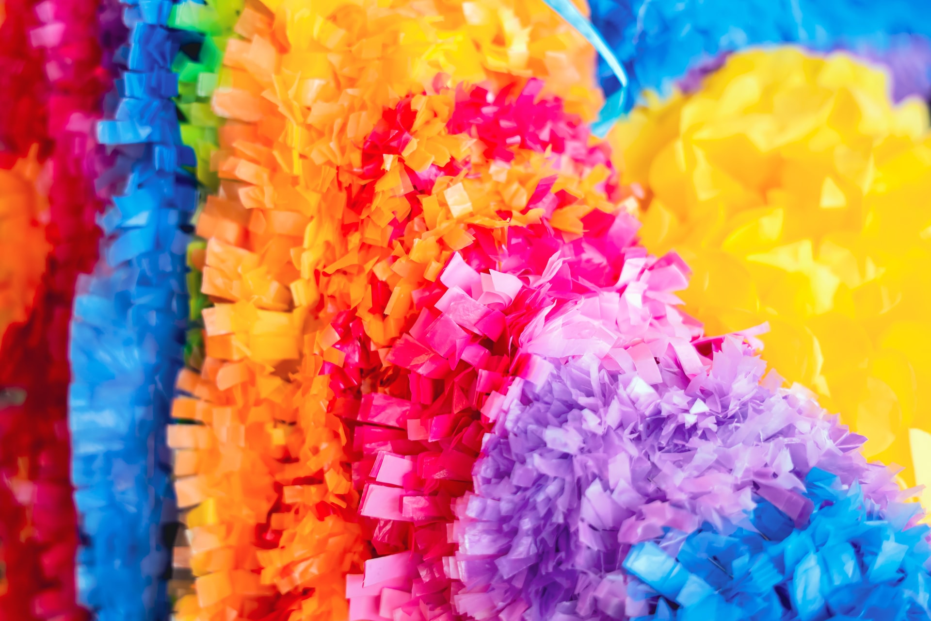 closeup shot of a pompom sporting the colors of the rainbow