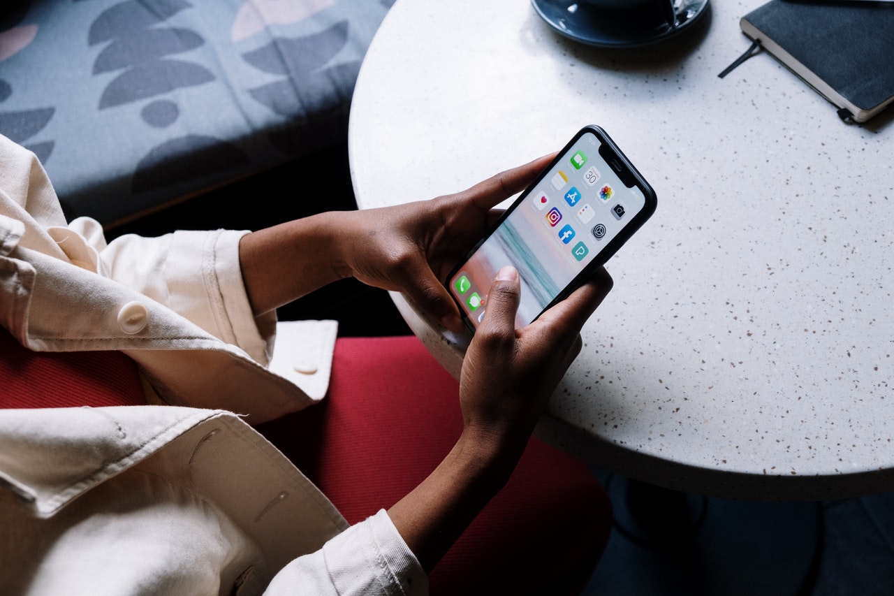 a woman scrolling through her phone's social media apps