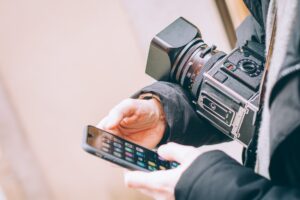 a social media content creator on their phone during a video shoot break