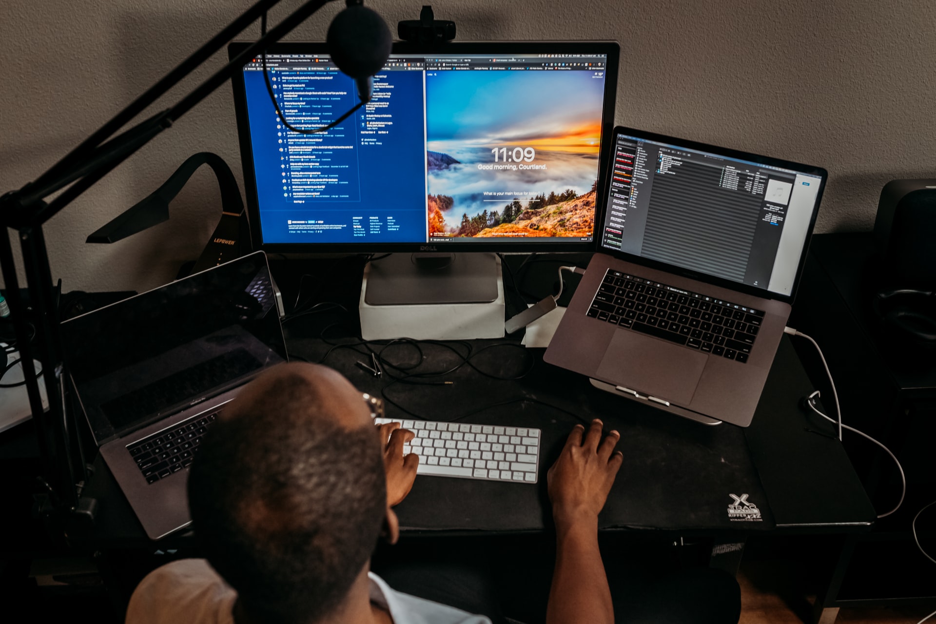 Working With Content Creators: 5 Things You Need to Know 2 a man working on a project using multiple screens and laptops