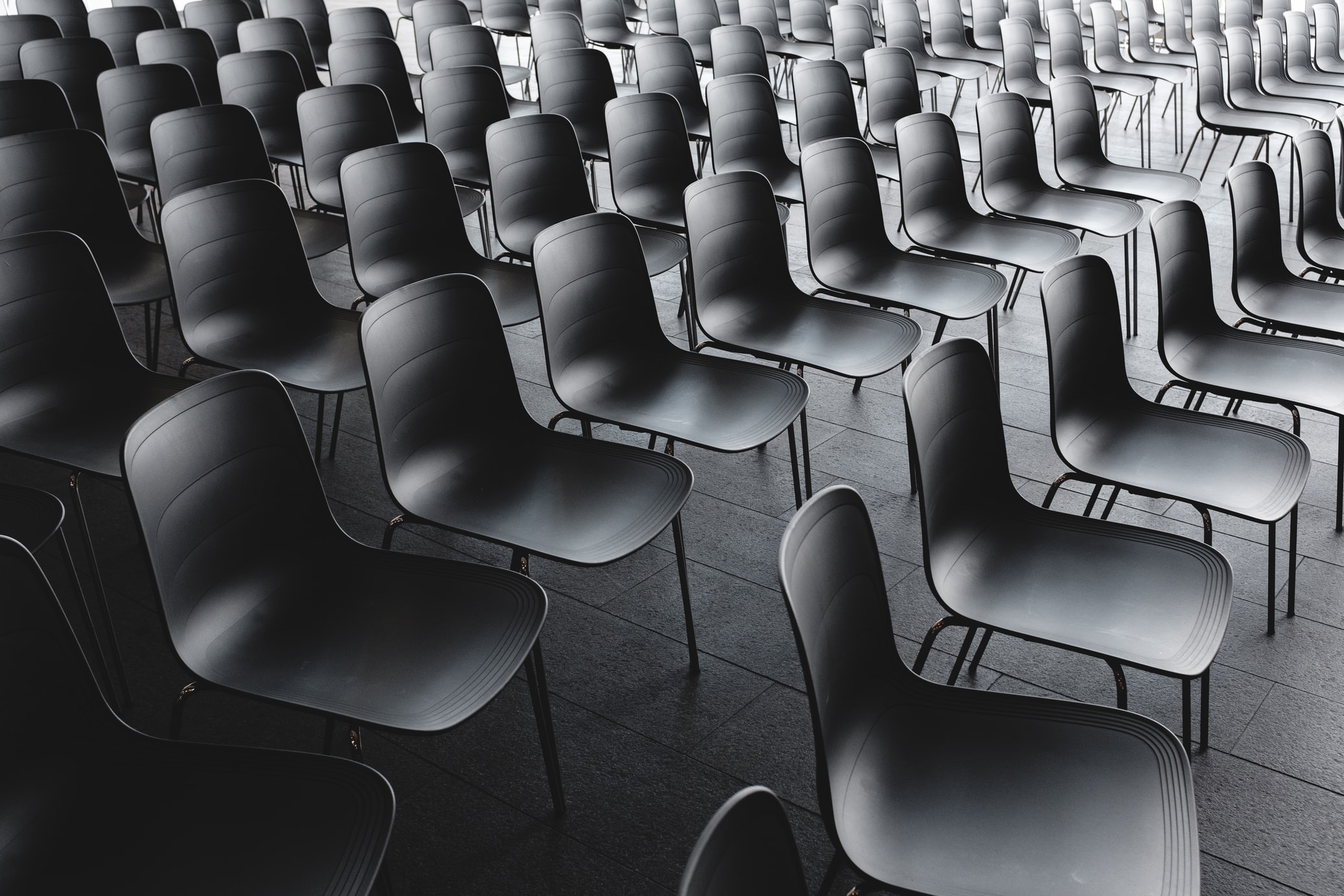 black chairs arranged in a line for an event