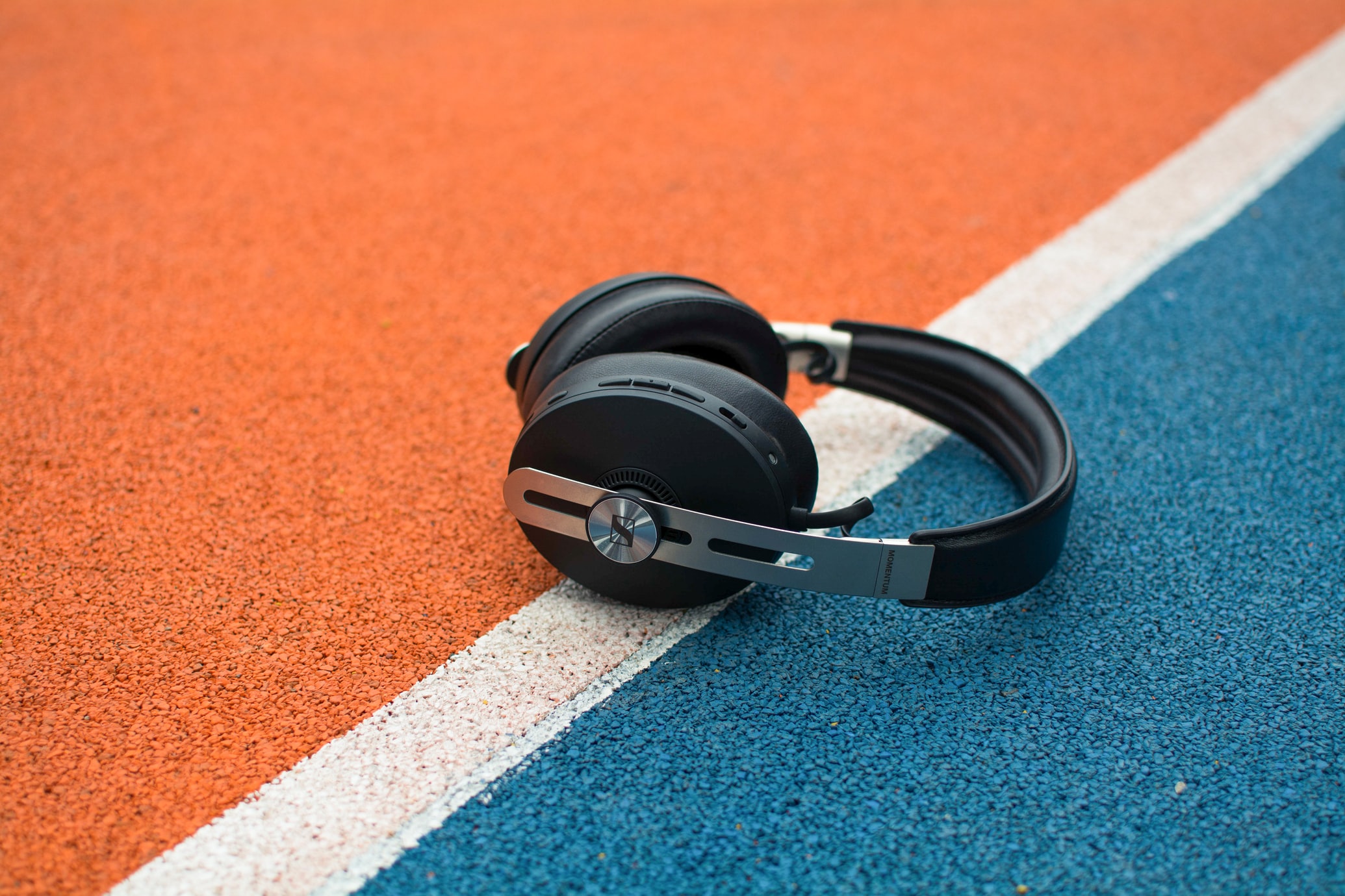 a pair of headphones on a blue and orange-painted court