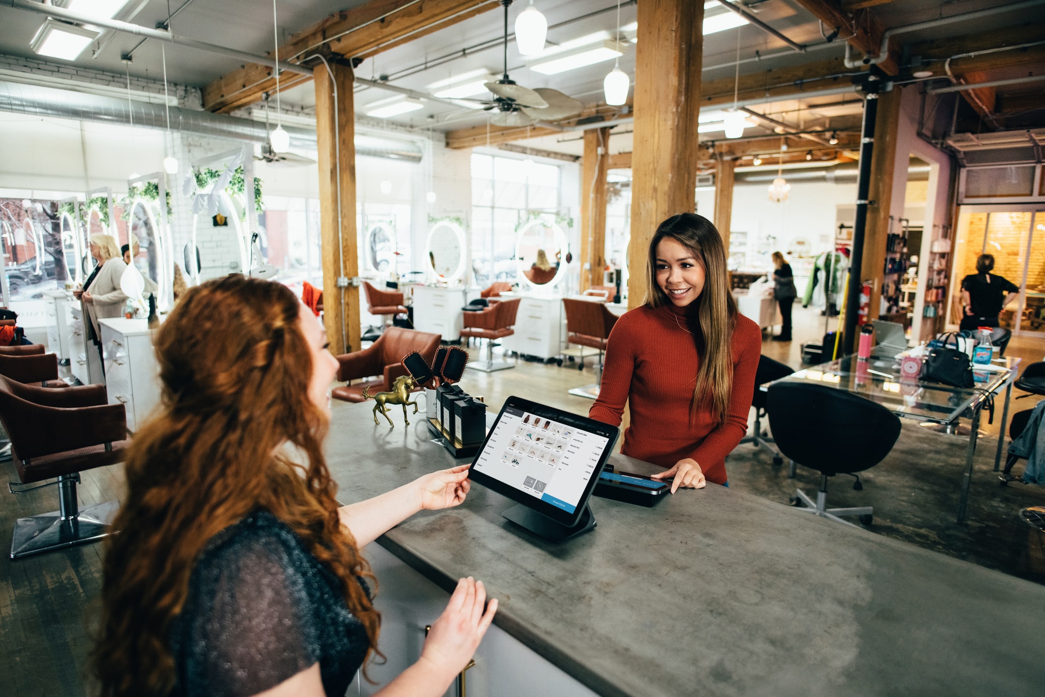 a woman paying for her items to a female cashier