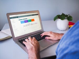 a digital marketer checking the organic SEO stats of his website on a macbook air