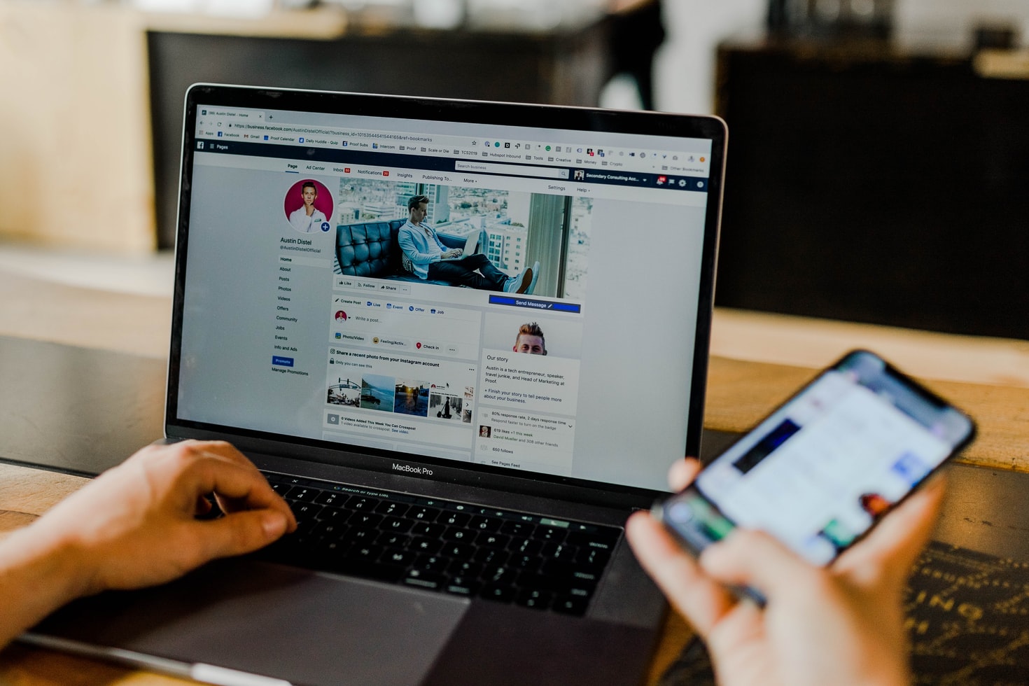 a marketer checking his facebook page on a laptop and phone