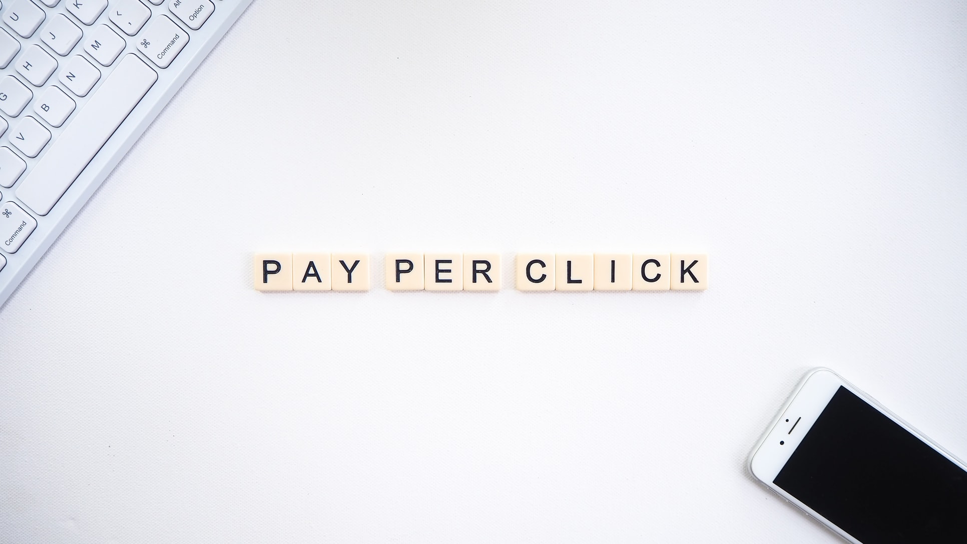 scrabble tiles laid out on a table spelling pay-per-click