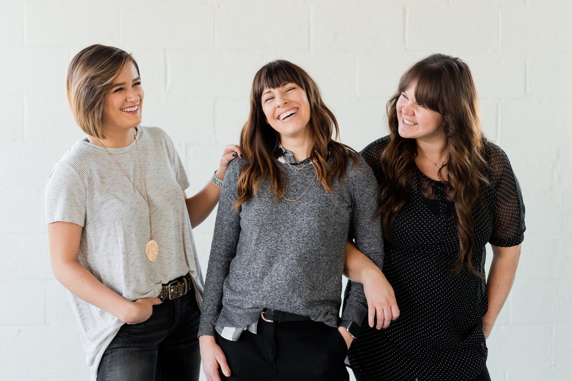 female business owners share a laugh as they discuss social media marketing trends