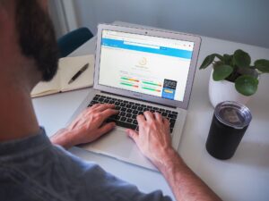 man using a macbook air to complete white label seo tasks
