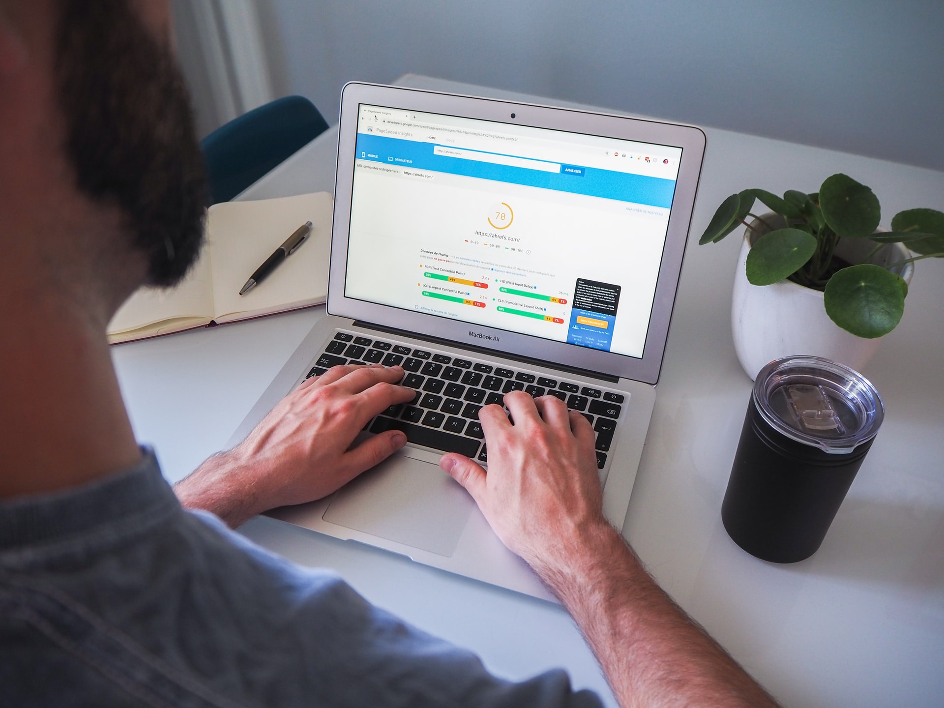 man using a macbook air to complete white label seo tasks
