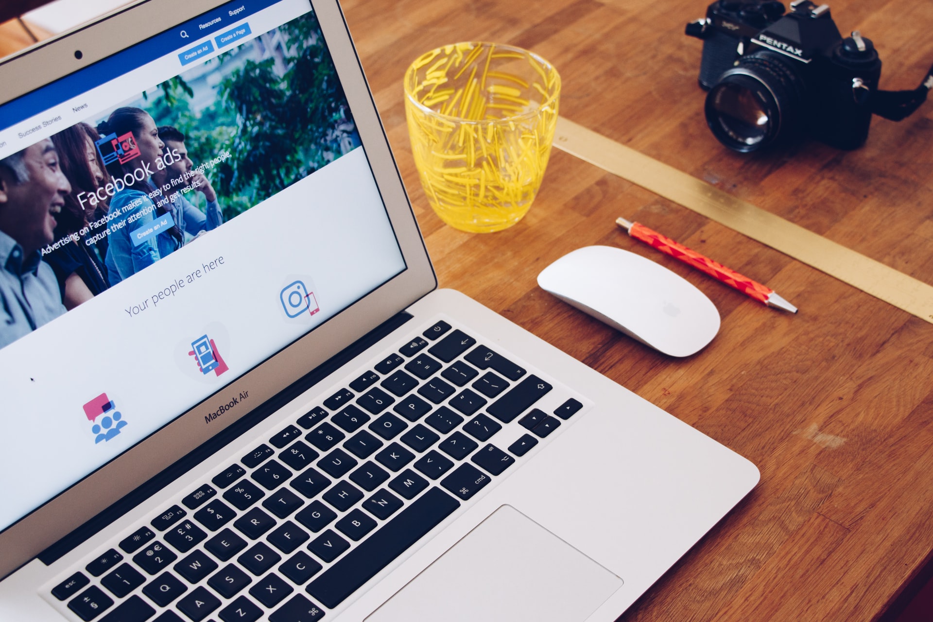 a laptop on a desk showing the home page of a facebook ad audience tool